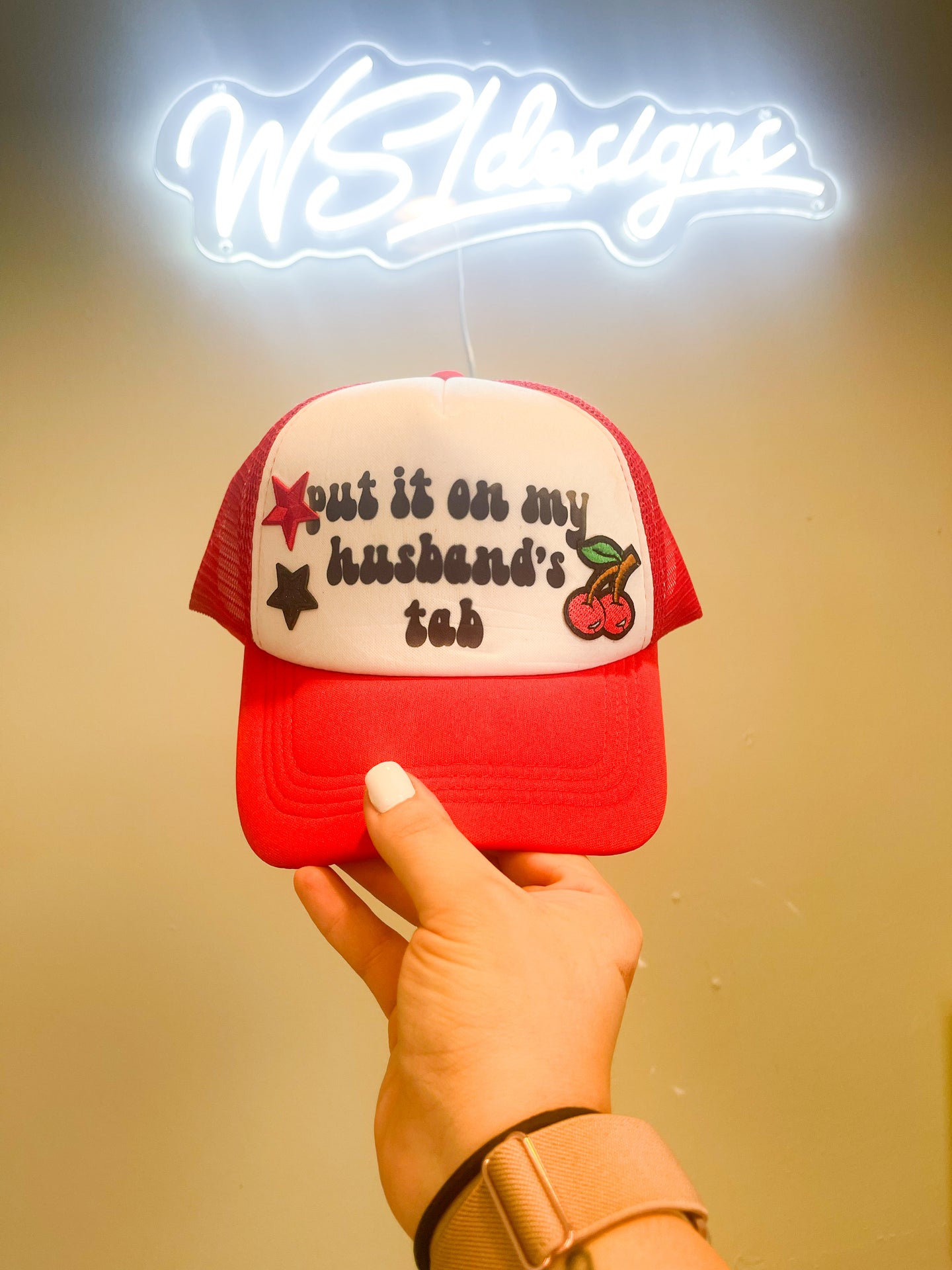 “put it on my husband’s tab” trucker hat